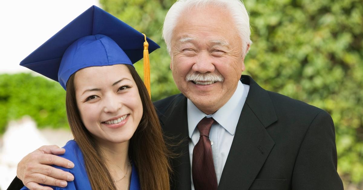 happy female graduate and grandfather