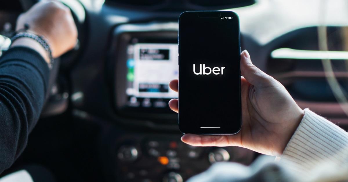 woman using uber application on smartphone