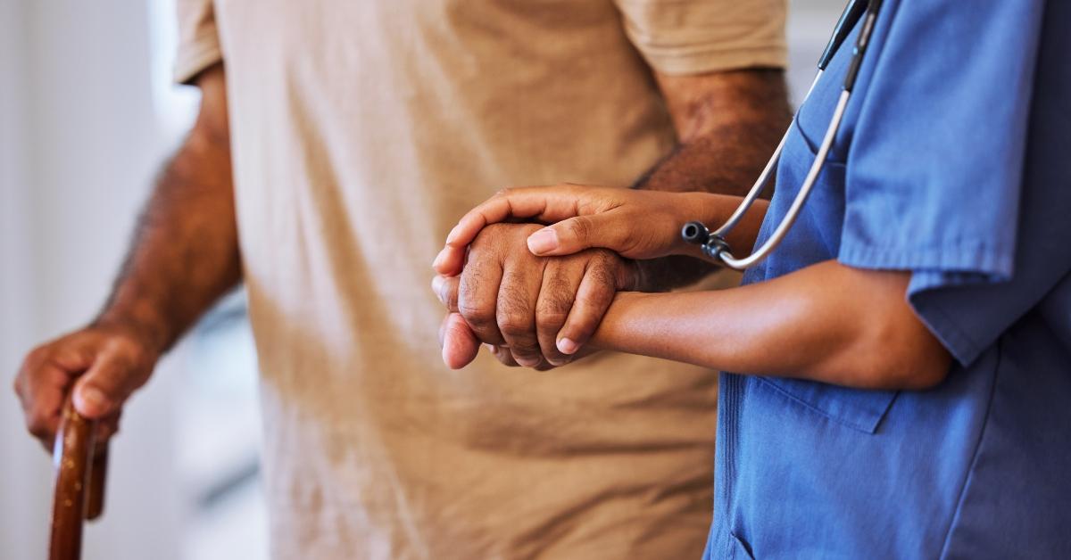 nurse walking with senior man