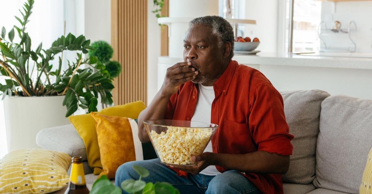 african american man eating popcorn
