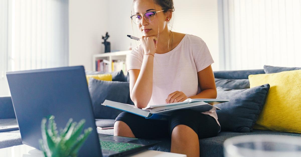 woman studies in front of the laptop