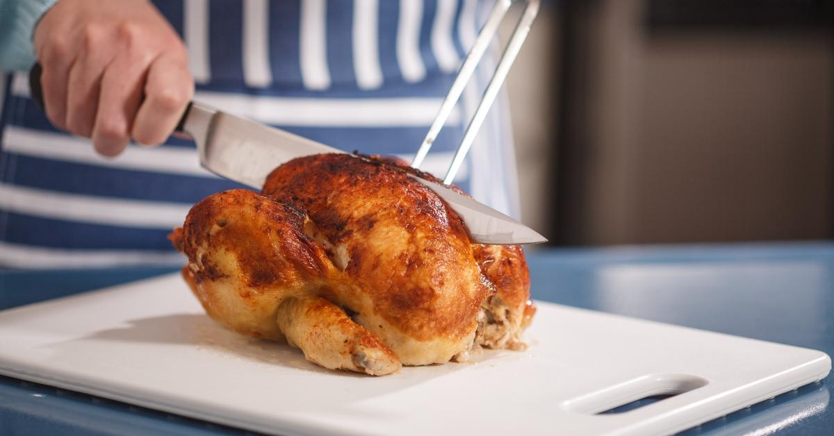 slicing chicken on cutting board