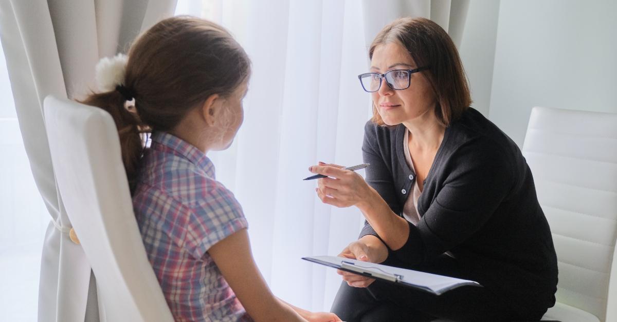 woman social worker talking to girl
