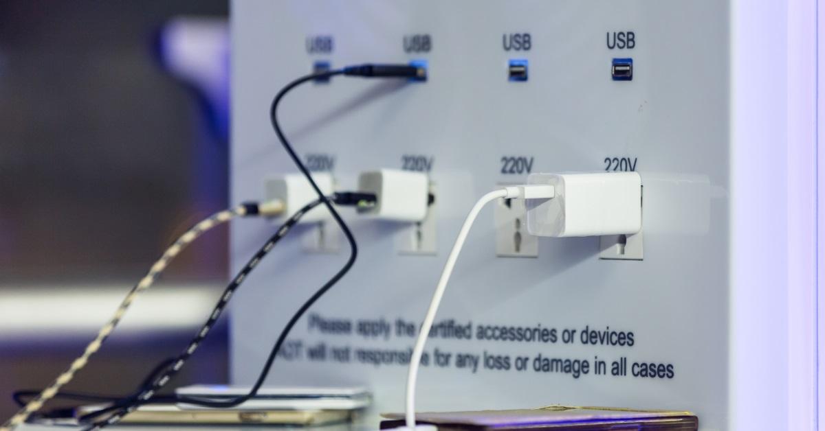 passengers charging smartphone at airport
