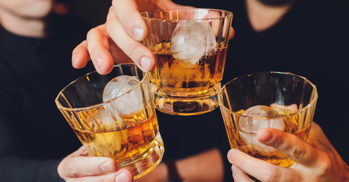 clinking glasses with alcohol