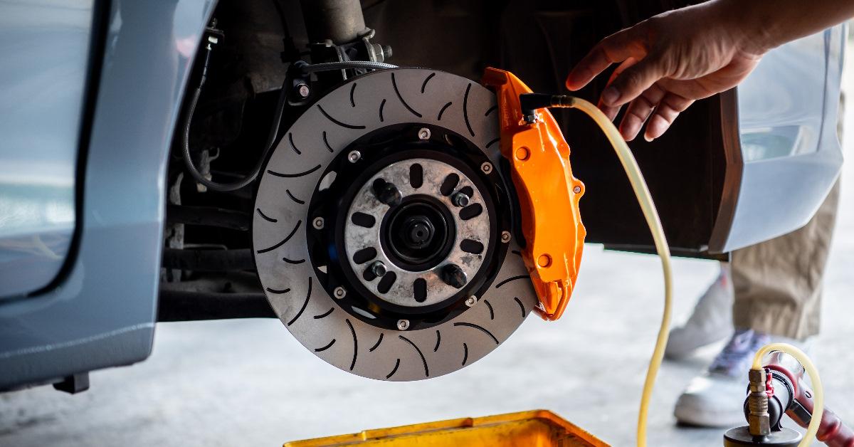 mechanic inspecting disc brakes at workshop