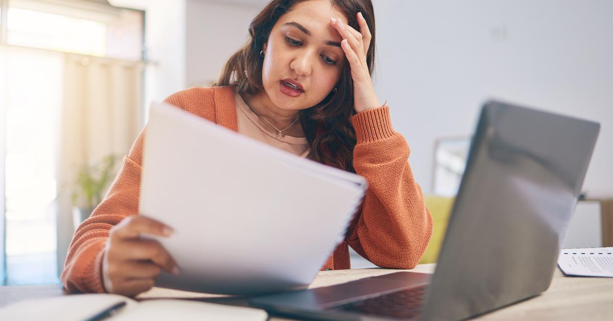 woman on laptop with paperwork
