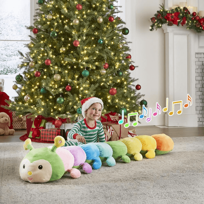 kid playing with musical plush caterpillar