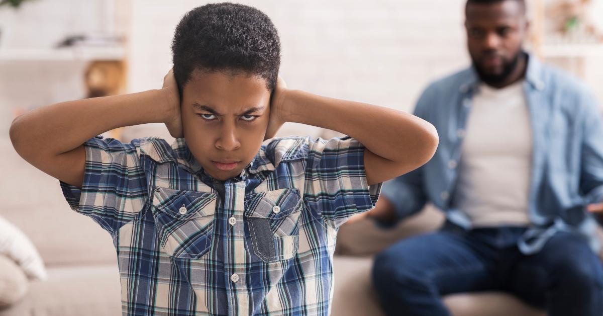 preteen black boy closing ears