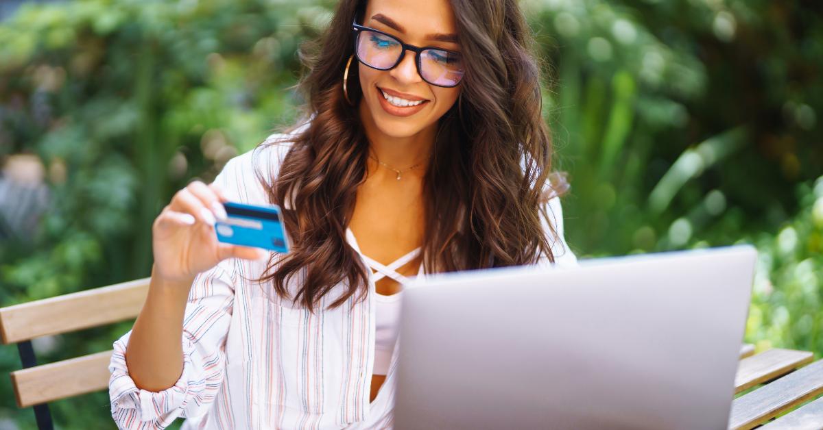 woman using credit card and laptop