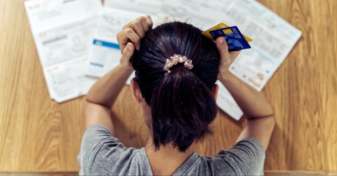 Stressed woman looking at bills
