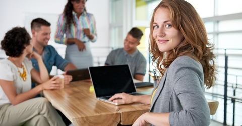 businesswoman smiling at desk