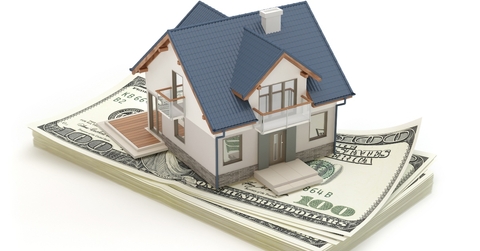 Model house sitting on money