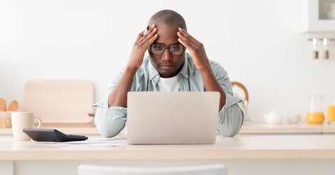 Worried man looking at computer