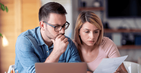 Worried couple looking at paperwork