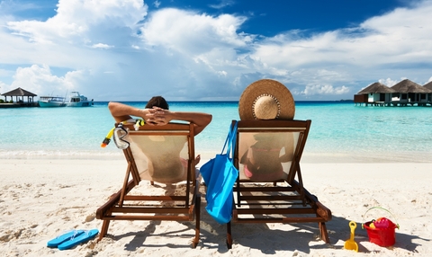 couple relaxing by the beach on a vacation