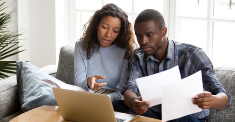 African American couple discussing about paper documents