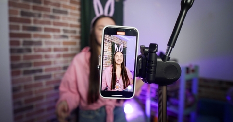 TikTok creator talking in front of a camera phone