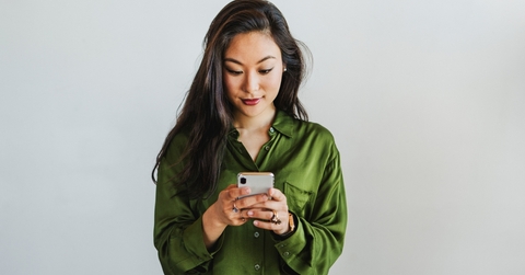 Smiling woman looking at phone