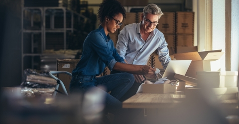 Two people discussing business credit card application