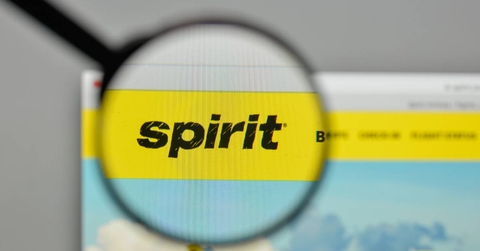 A magnifying glass hovering over the Spirit Airlines logo on the website homepage.