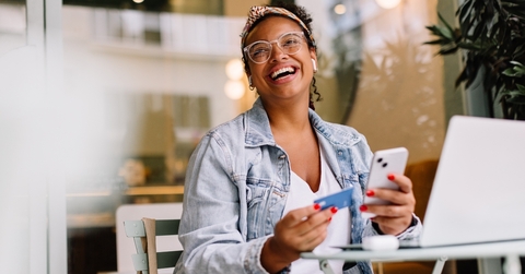 Smiling woman using a credit card