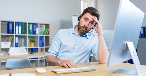 tired man working at a computer