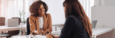 two women talking at bank