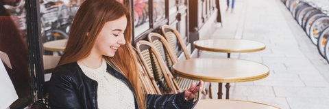 Woman sitting outside cafe