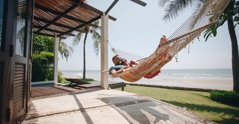 couple relaxing in a hammock by the beach