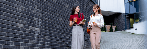 two professionally dressed people walking down street