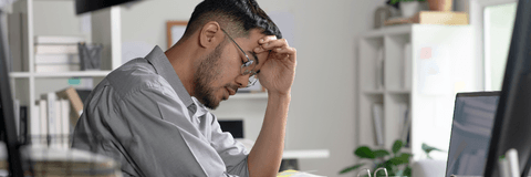 Man looking stressed at computer
