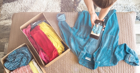 Person taking photos of clothes to resell