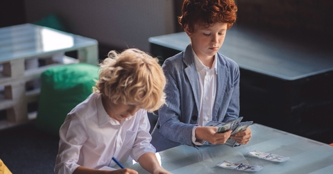 Two friends counting saved money and looking involved