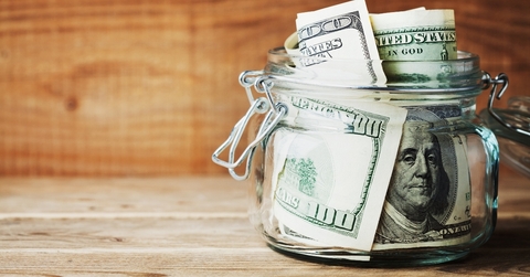 Jar filled with dollar bills