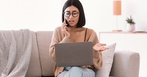 woman talking on mobile phone sitting on sofa