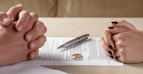 couple signing divorce paperwork