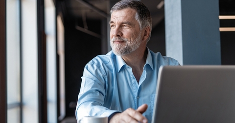 Mature businessman working on laptop
