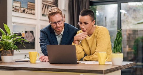 mixed races couple sitting in living room discussing