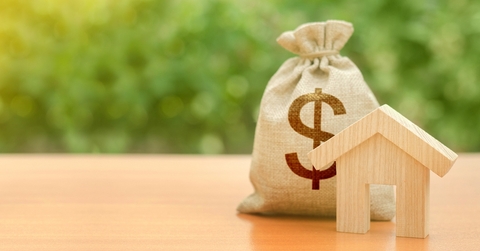 Wooden toy house with money bag