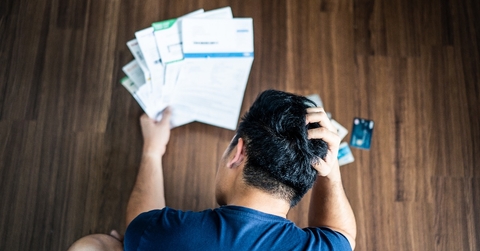 stressed young asian man hands holding the head 