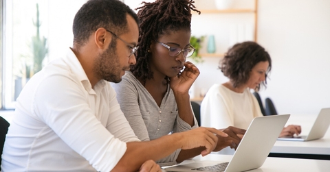 Instructor explaining corporate software specific to intern
