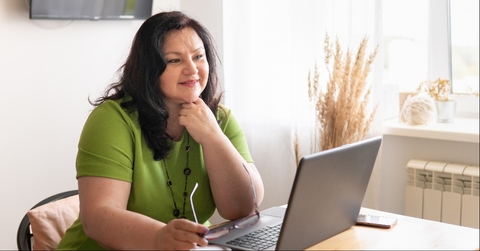 woman in the office sitting at a desk with a laptop
