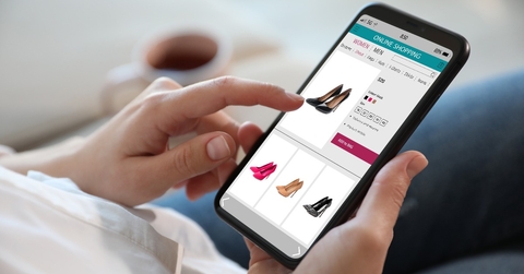 Woman shopping online via smartphone indoors