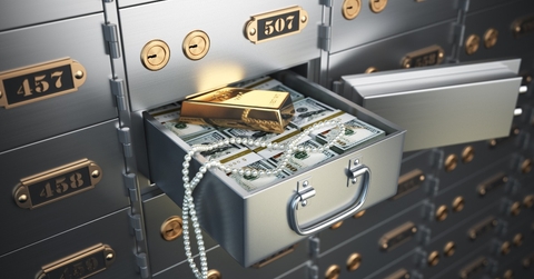 Open safe deposit box with money jewels and golden ingot