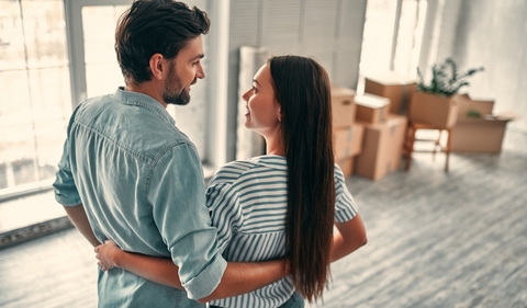 Couple looking at each other in new home