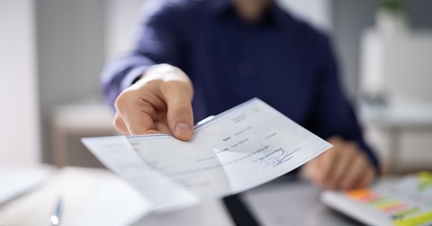 businessperson hands giving cheque