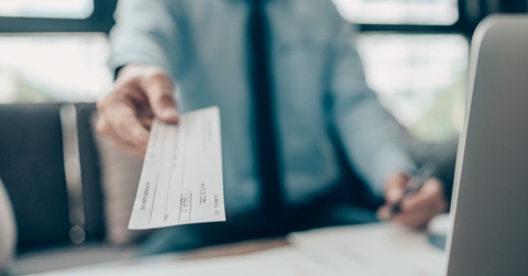  hand giving cheque to customer