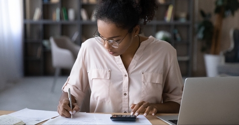woman sitting at desk managing budget 