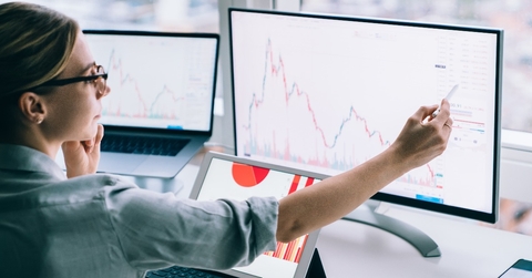 professional woman working with graphs on computer